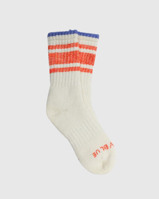 Off White The Hemp Yarn Varsity Hiker Full Cushion Boot Sock (Angle): Cream ribbed sock with red stripes, blue cuff, brand text on sole