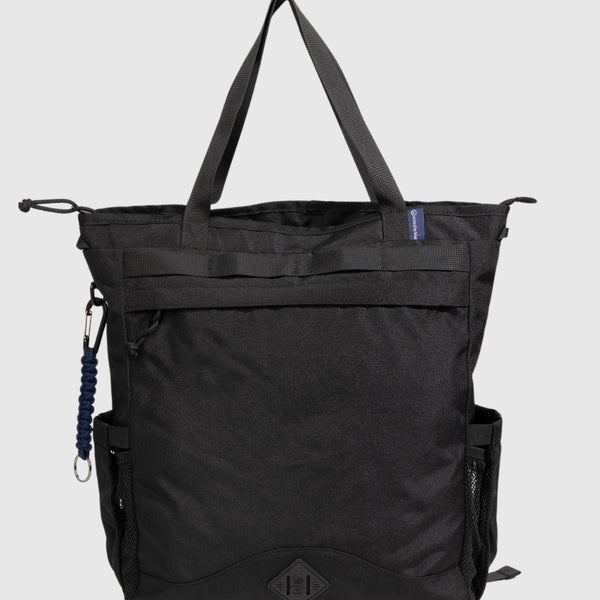 Black (R)evolution™ 25L Convertible Carryall (Front): Black tote bag with top handles, front zipper pocket, mesh side pocket, carabiner clip, and logo patch