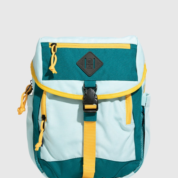 Teal (R)evolution™ 9L Sidekick (Front): Light blue and teal backpack with yellow straps, buckle, and zipper accents