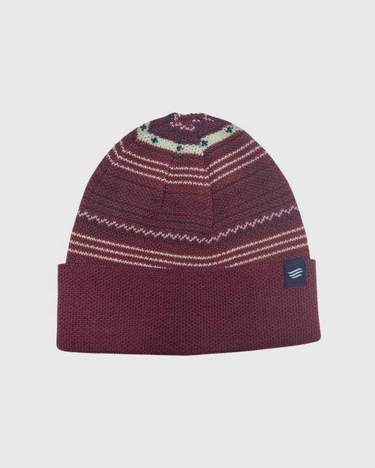 Burgundy Multi Merino Wool Modern Fair Isle Knit Beanie (Angle): Dark red knit beanie with Fair Isle pattern, cream stripes, folded cuff, small navy logo patch
