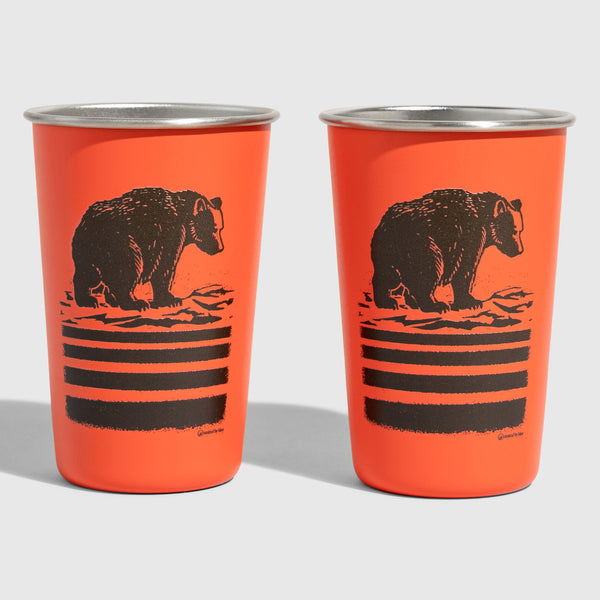 Orange Bears 16OZ STAINLESS STEEL TUMBLERS (Front): Two orange steel cups with dark brown bear illustration and horizontal stripes