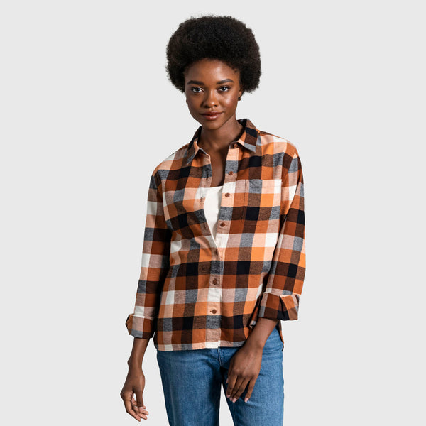 Sunburn The Responsible Flannel - Impact Collection (In-use): Woman wearing open orange, navy, and cream plaid flannel shirt over white top