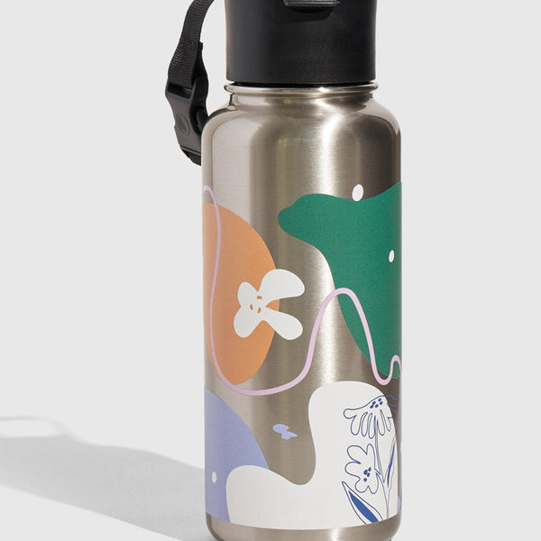 Illuminate Bottle - 23 Oz. Insulated Stainless Steel (Angle): Silver stainless bottle with colorful abstract shapes, black flip-top lid, strap