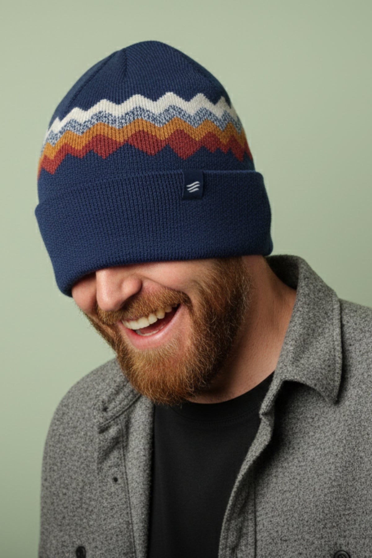 Navy Merino Wool Mountain Scape Knit Beanie (In-use): Laughing bearded man wearing navy zigzag knit beanie pulled over eyes