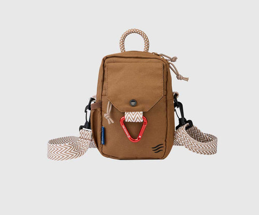 Tigers Eye (R)evolution™ Daily Cross Body (Front): Tan canvas crossbody bag with chevron strap, red carabiner, and rope handle