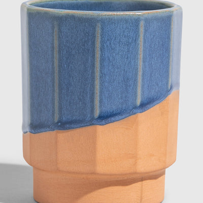 Cobalt 8 oz. Stackable Stoneware Tumbler (Angle): Faceted ceramic tumbler, upper half blue glaze, lower half unglazed terracotta