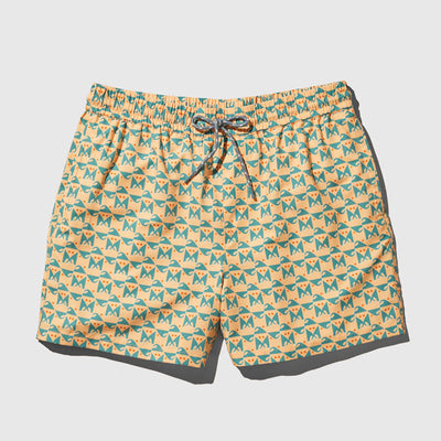 Buff Orange Recycled Swim Trunk - 5" (Flat-lay): Yellow swim trunks with teal cat geometric repeat print and drawstring waist