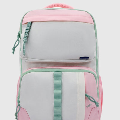 Light Pink (R)evolution™ 25L Transit Pack (Front): Pink and light gray backpack with mint green zipper trim and straps