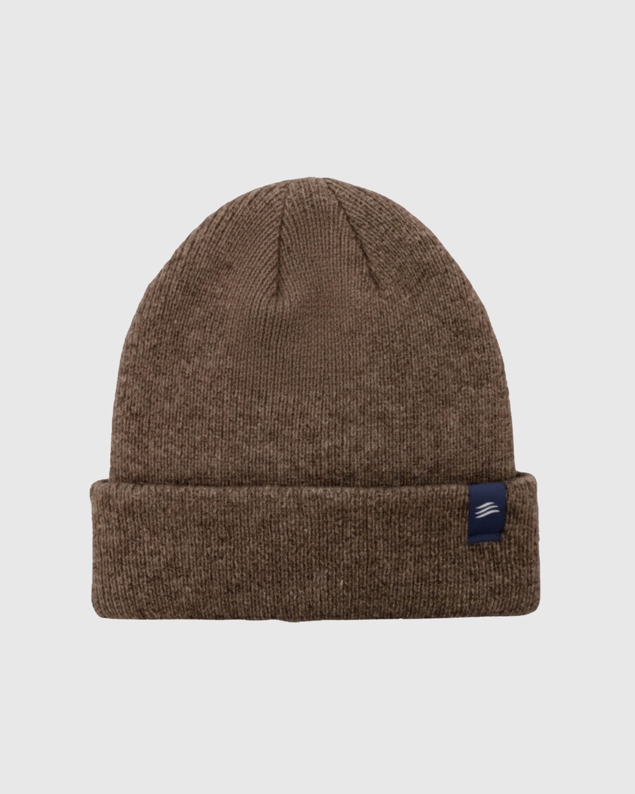 Brown knit beanie with a blue label on a light gray background