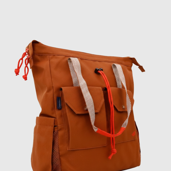 Rustic Caramel (R)evolution™ 27L Utility Convertible Tote (Front): brown caramel tote with red drawstring accents