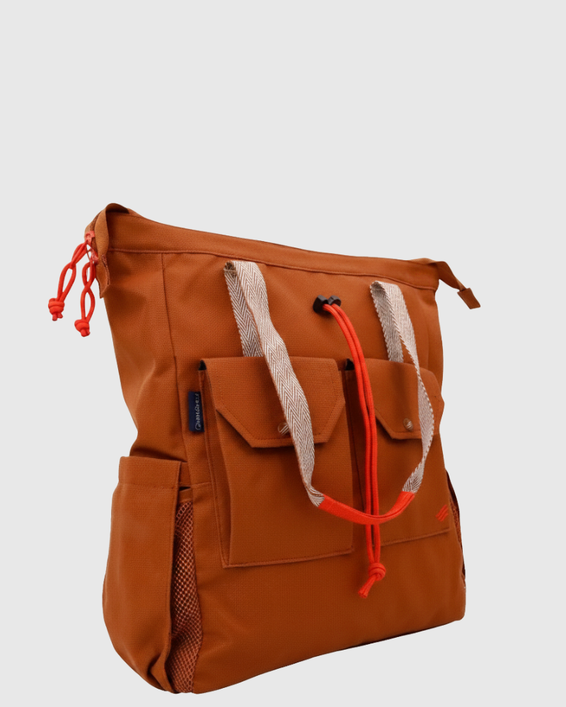Rustic Caramel (R)evolution™ 27L Utility Convertible Tote (Front): brown caramel tote with red drawstring accents