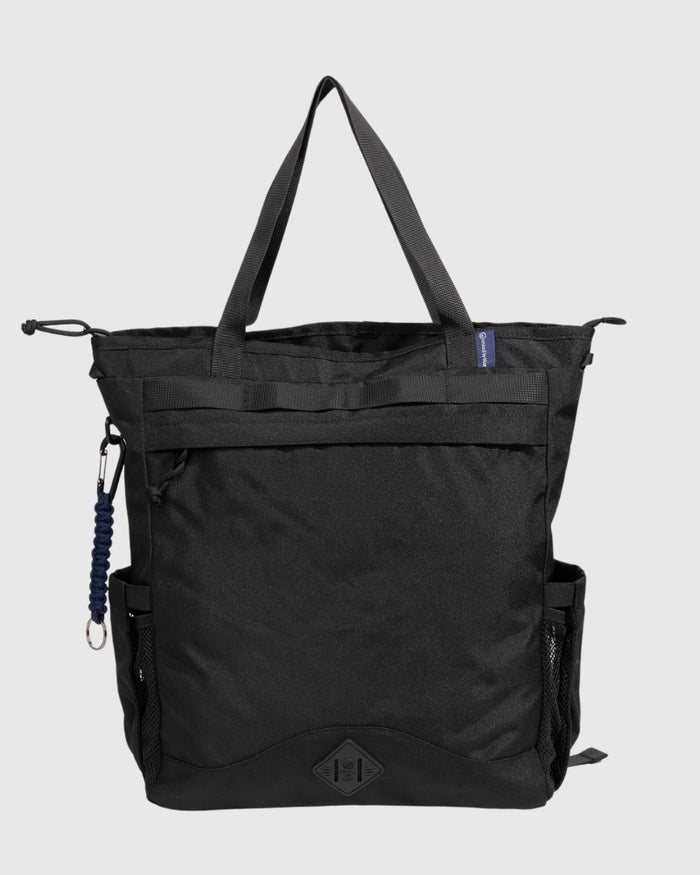 Black (R)evolution™ 25L Convertible Carryall (Front): Black tote bag with top handles, front zipper pocket, mesh side pocket, carabiner clip, and logo patch