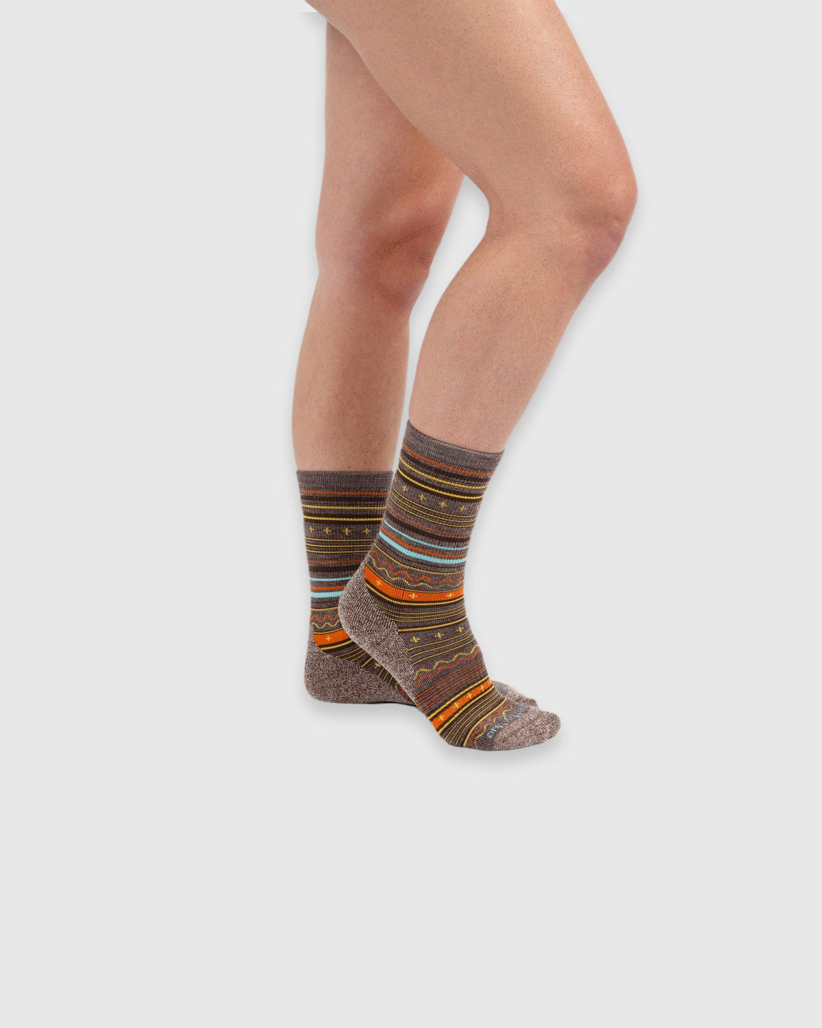 Merino Wool Trail Crew Sock - New Color (In-use): Brown patterned merino crew socks worn on feet, side view