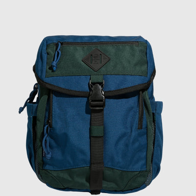 Blue W/ Green (R)evolution™ 9L Sidekick (Front): Two-tone blue and green backpack with black buckle strap and zipper pockets