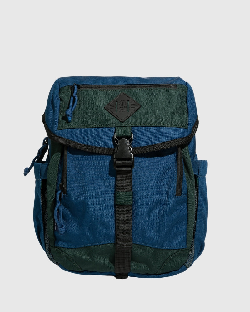 Blue W/ Green (R)evolution™ 9L Sidekick (Front): Two-tone blue and green backpack with black buckle strap and zipper pockets