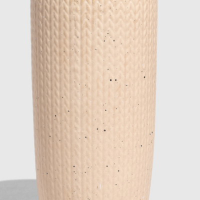Shortbread-Knit 10 oz. Insulated Stoneware Travel Mug (Front): Tall cream speckled stoneware cup with knit texture and black lid clip