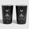 Lunar Moth 16OZ STAINLESS STEEL TUMBLERS (Front): Two black stainless tumblers with moth, crescent moon, and fern print