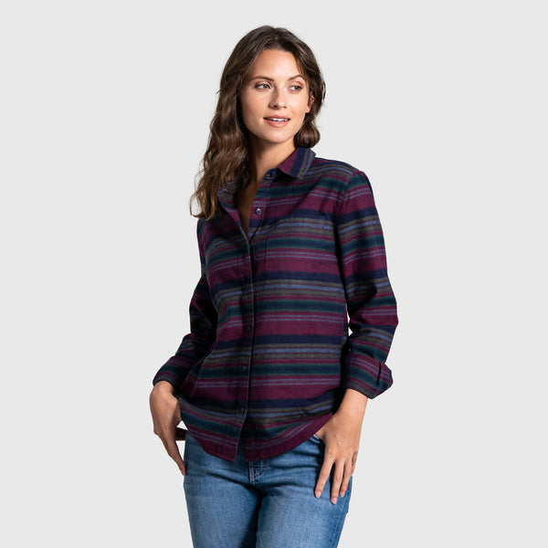 Rhododendron The Responsible Flannel - Impact Collection (Angle): Woman wearing dark multicolor striped flannel button-up shirt with jeans