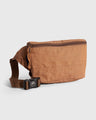 Camel Deadstock (R)evolution™ Canvas Fanny Pack (Angle): Tan canvas belt bag with brown zipper, stitching details, and buckle strap