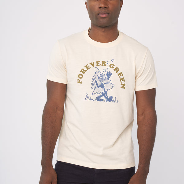 Shortbread Forever Green Graphic Tee (In-use): Man wearing cream tee with blue dancing tree cartoon and gold arc text