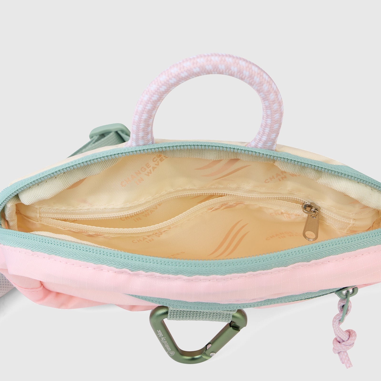 Lt. Pink (Re) Active Bum Bag (Interior): Open bum bag showing tan printed lining, interior zip pocket, and mint rope handle