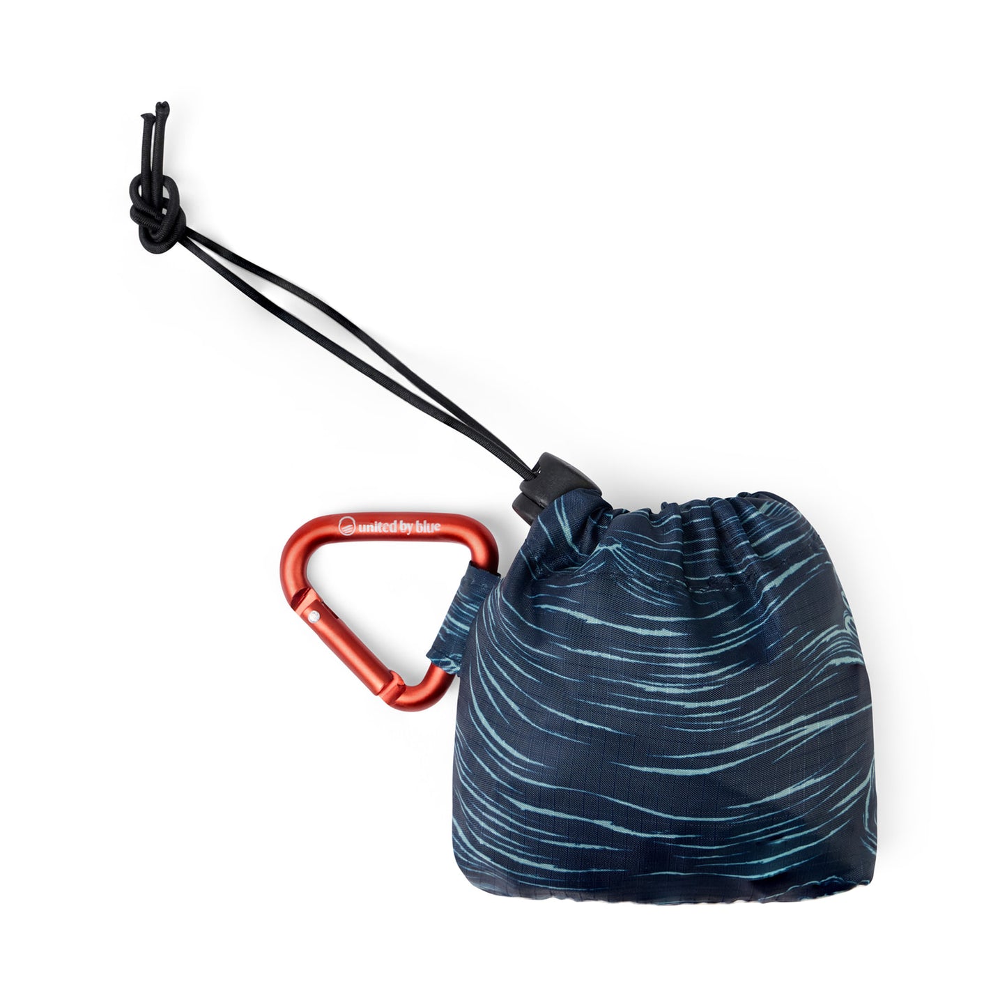 Waves The Packable Tote (Packed): Navy wave-print tote folded into stuff sack with red carabiner clip and black bungee toggle