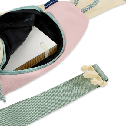 Pink Multi (R)evolution Sling Pack (Interior): Open sling pack revealing dark interior with notebook inside, plus adjustable strap with buckle