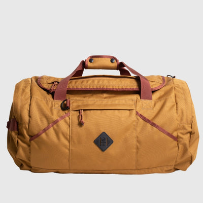 Camel (R)evolution™ 55L Carry-On Duffle (Front): Tan canvas duffle with burgundy handles, straps, front zip pocket, diamond logo patch