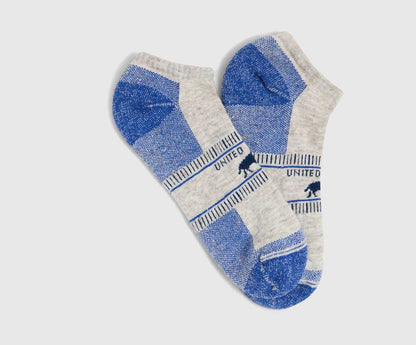 Blue Bison Trail Low-Cut Sock (Flat-lay): Two low-cut ankle socks, gray with blue heel, toe, and stripe accents