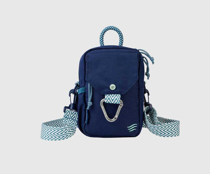 Navy (R)evolution Daily Cross Body (Front): Navy crossbody bag with mint accents, silver carabiner, snap-flap pocket, and zigzag chevron strap