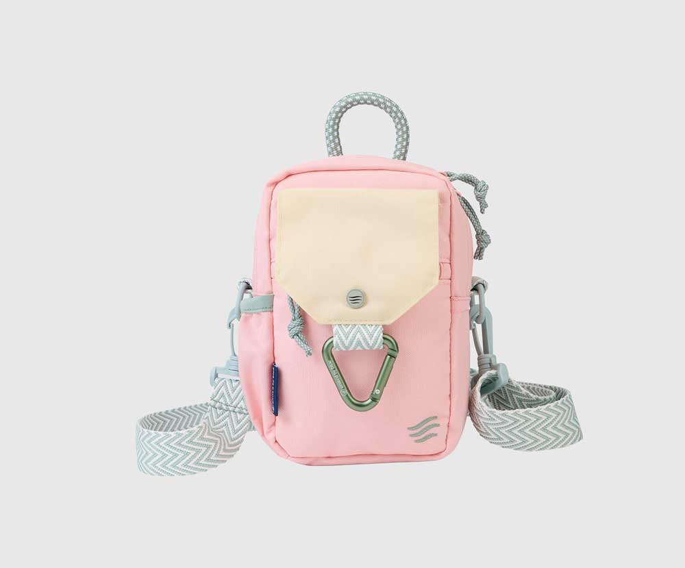 Lt Pink (R)evolution™ Daily Cross Body (Angle): Small pink crossbody bag with cream front pocket, carabiner clip, and woven strap