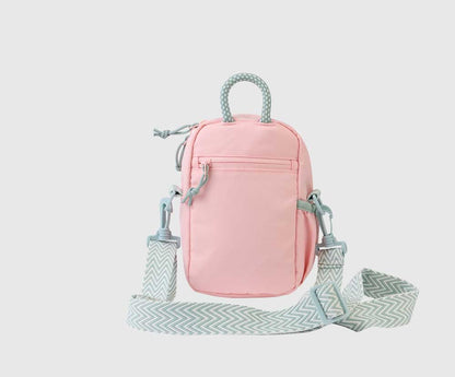 Lt Pink (R)evolution Daily Cross Body (Back): Pink crossbody back panel with horizontal zip pocket, rope handle, and removable chevron strap