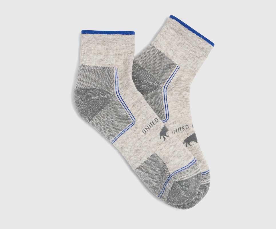 Grey Bison Trail Quarter Sock (Flat-lay): Pair of light grey quarter socks with blue trim and bison logo