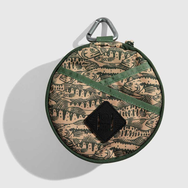 Cortado The Meal Kit (Single) (Front): Round tan pouch with fish print, green straps, carabiner clip, diamond logo patch