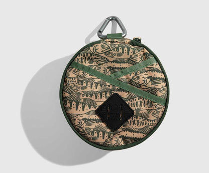 Cortado The Meal Kit (Single) (Front): Round tan pouch with fish print, green straps, carabiner clip, diamond logo patch