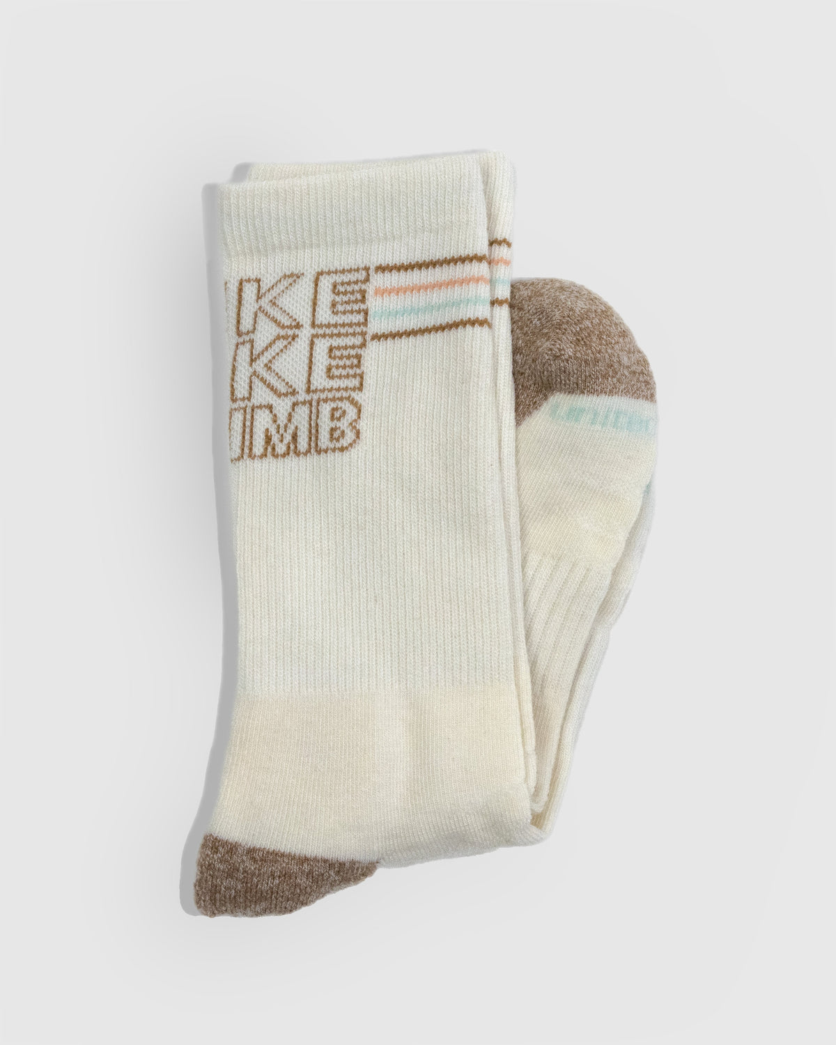 HikeBikeClimb - Natural Merino Wool - Graphic Crew Sock (Detail): Folded cream crew sock showing knit text graphic and brown toe