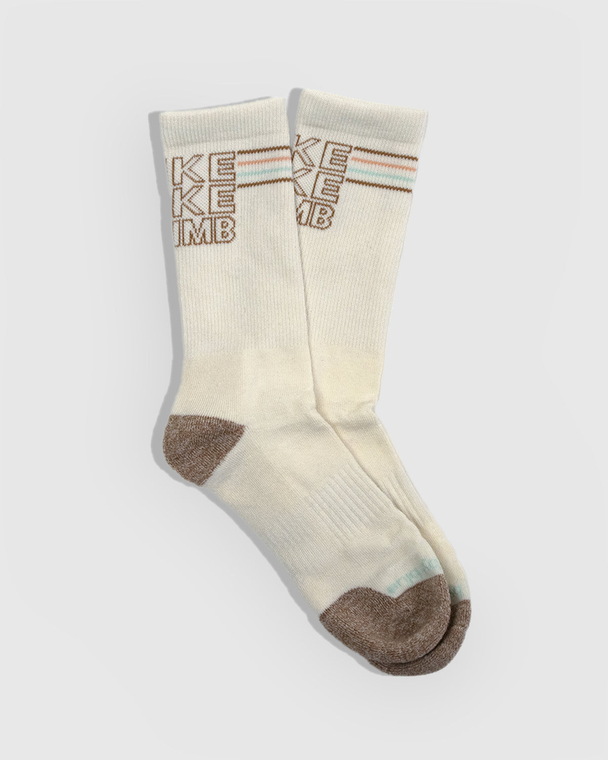HikeBikeClimb - Natural Merino Wool - Graphic Crew Sock (Flat-lay): Cream crew socks with brown knit HIKE BIKE CLIMB text and toe
