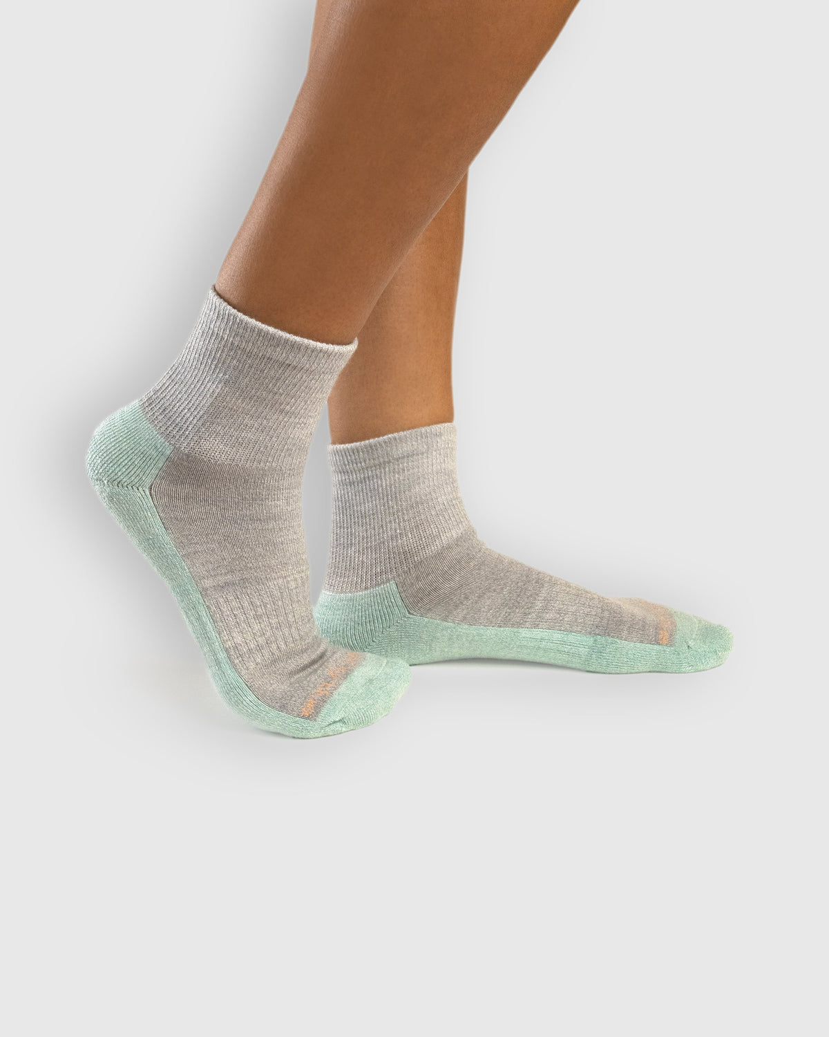Stone Marled Merino Wool - Marled Quarter Sock (In-use): Grey and mint marled merino quarter socks worn on feet, side view
