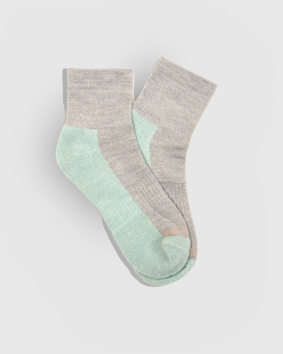 Stone Marled Merino Wool - Marled Quarter Sock (Flat-lay): Grey marled quarter socks with mint green heel, sole and toe
