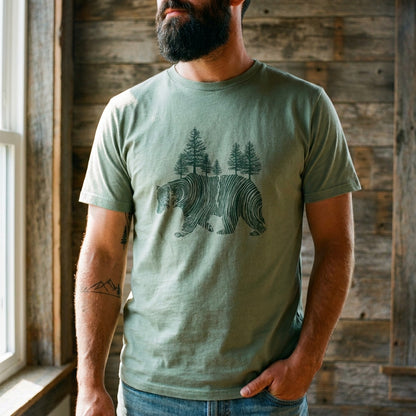 Olive Unisex Graphic Tee in 100% Organic Cotton - Pine Bear (In-use): Bearded man wearing sage green tee with woodcut bear and pine trees graphic