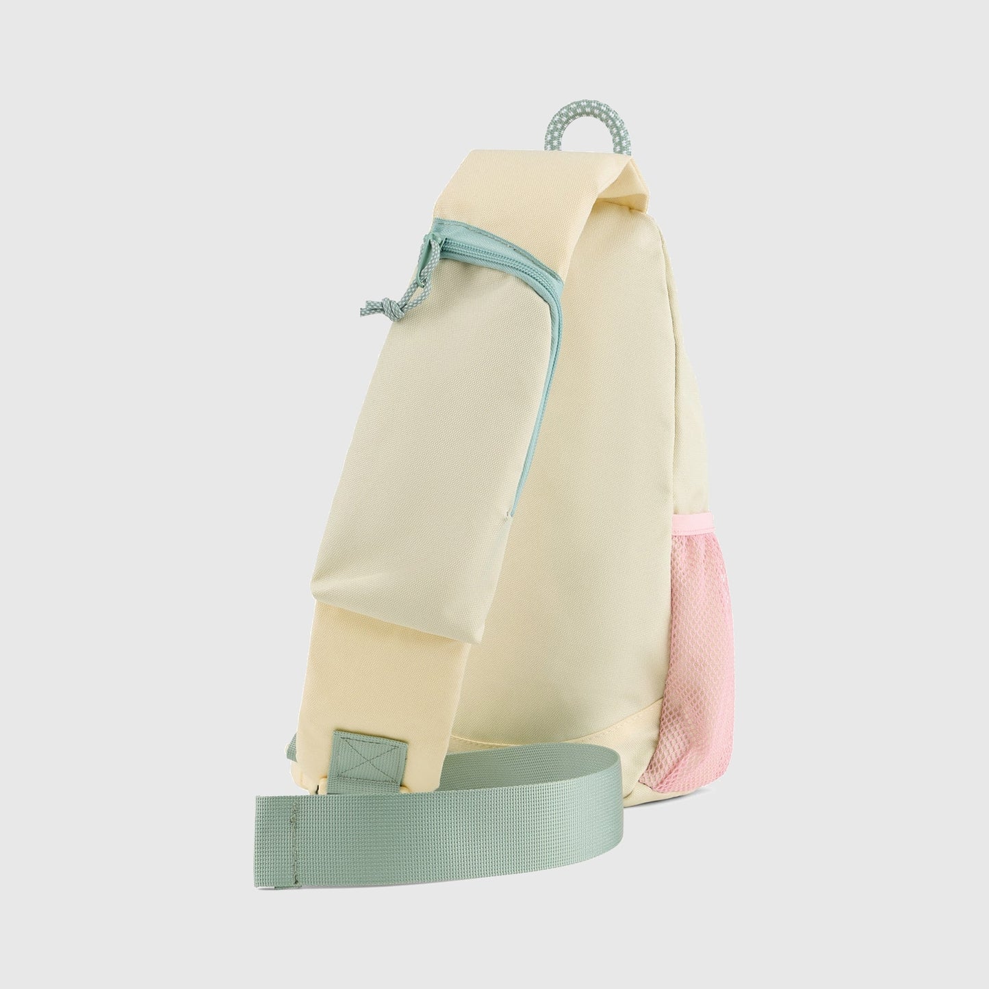 Pink Multi (R)evolution Sling Pack (Back): Cream side panel with mint zip pocket, mesh side pocket, and adjustable shoulder strap