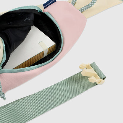 Pink Multi (R)evolution Sling Pack (Interior): Open sling pack revealing dark interior with notebook inside, plus adjustable strap with buckle