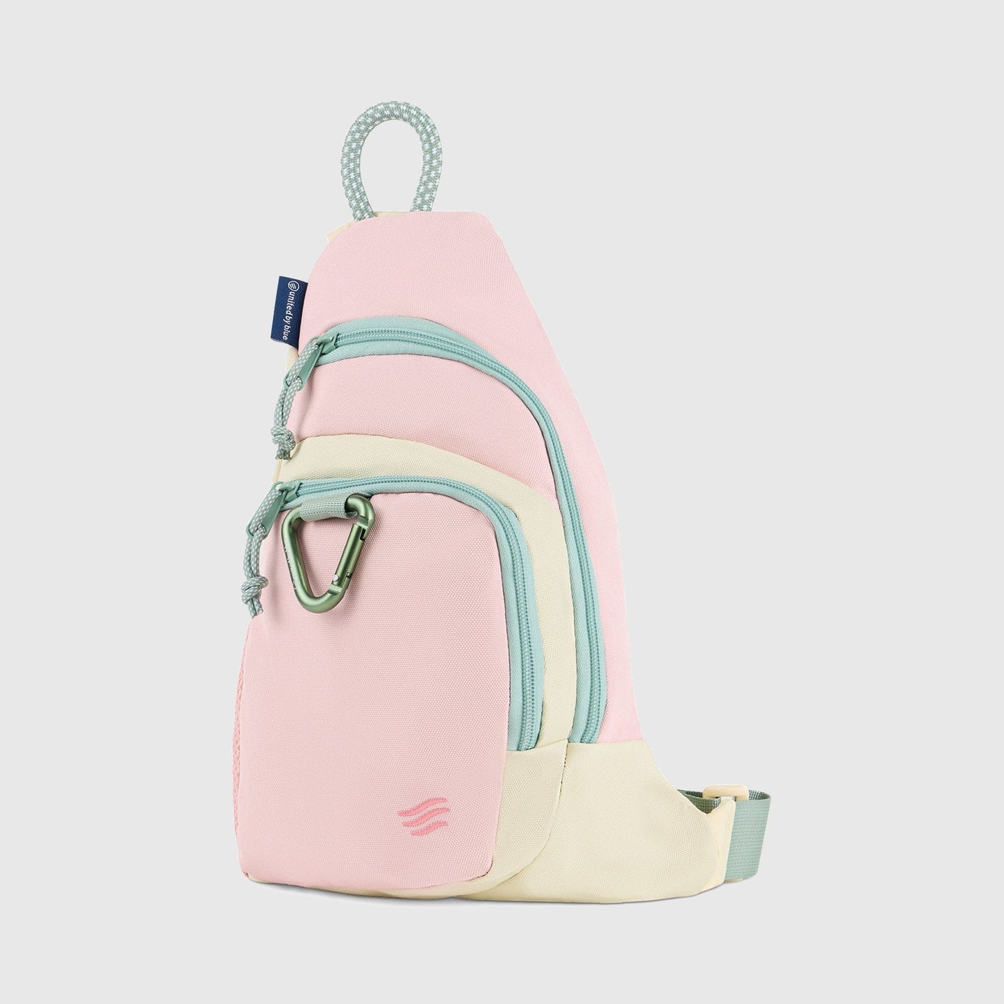 Pink Multi (R)evolution Sling Pack (Front): Pink and cream sling pack with mint zippers, green carabiner, and rope handle loop