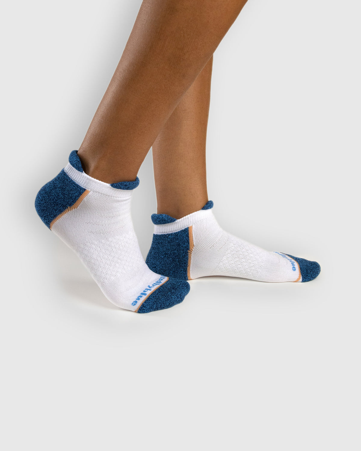White Rayon From Bamboo - Athletic Low Cut Sock - 2 Pack (In-use): White bamboo athletic low-cut socks with navy heel worn on feet