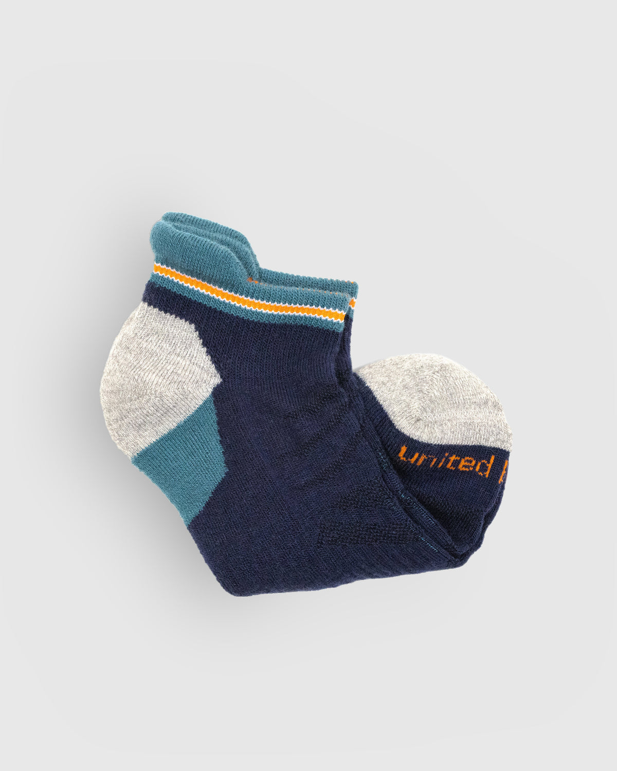 Midnight Merino Wool - Low Cut Sock (Detail): Folded navy low-cut sock showing teal tipped cuff and grey toe
