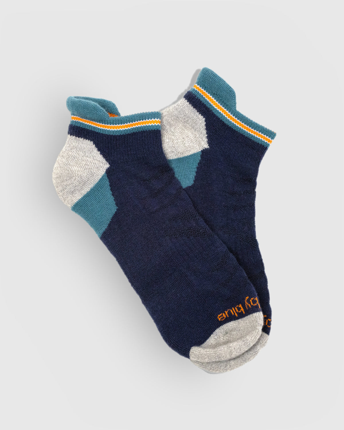 Midnight Merino Wool - Low Cut Sock (Flat-lay): Navy low-cut socks with teal cuff, orange stripe, grey heel and toe