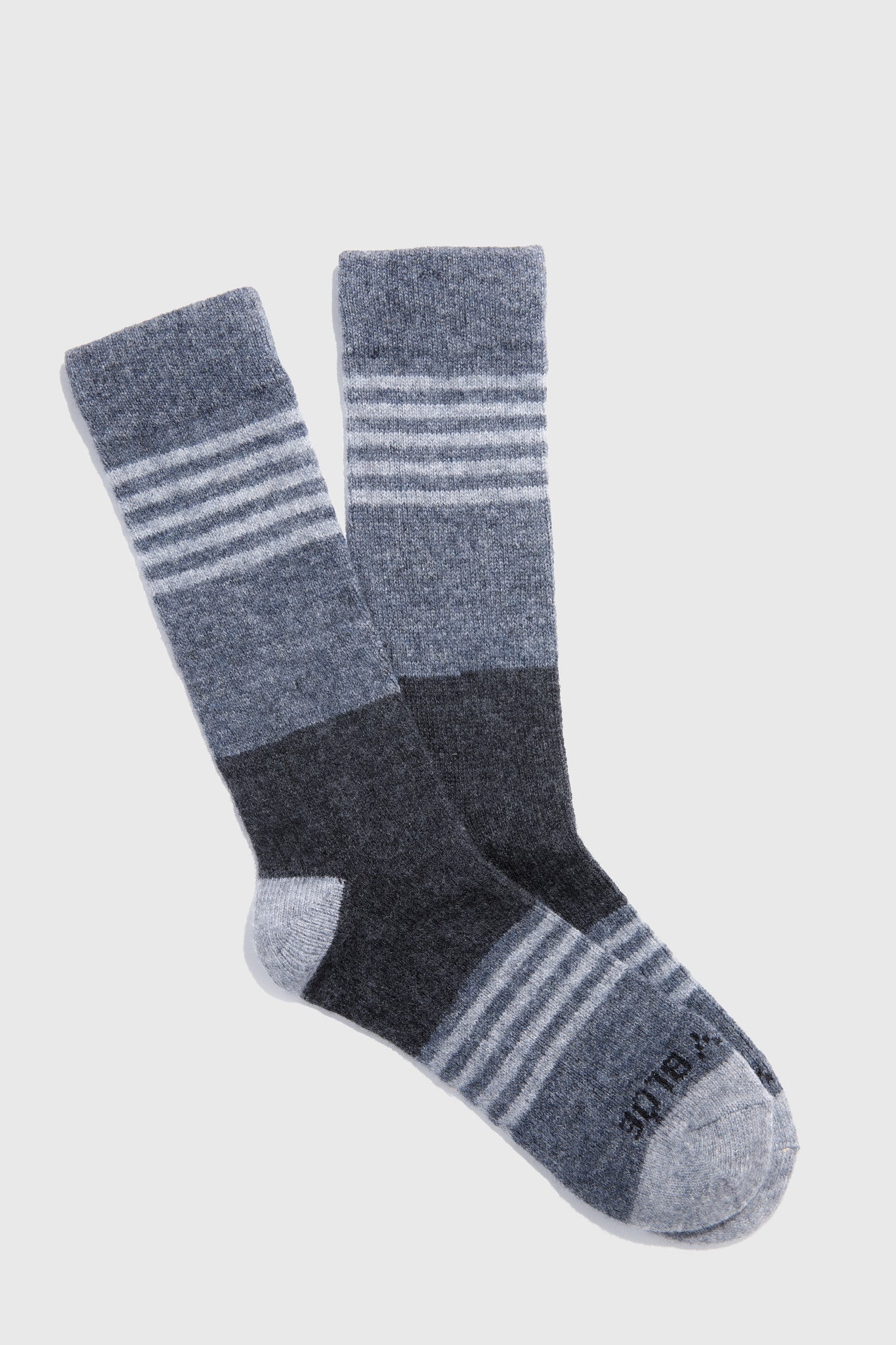 Pair of gray and black striped socks on a light gray background
