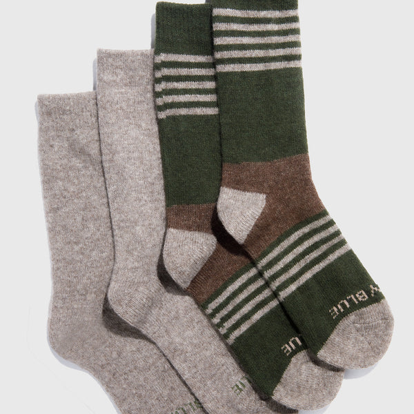 Three pairs of socks, two gray and one green with stripes, on a white background.
