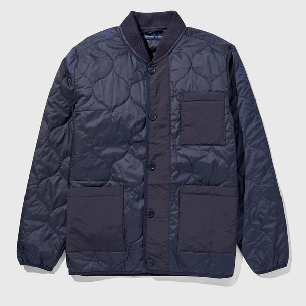 Night Sky Bison Ultralight Liner Jacket (Flat-lay): Navy quilted button-front jacket with ribbed collar and three patch pockets