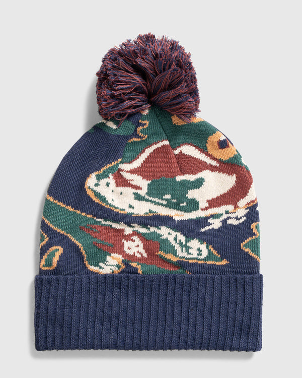 Lakeside Camo Recycled Novelty Pom Beanie (Flat-lay): Navy knit beanie with multicolor duck print and maroon pom-pom top